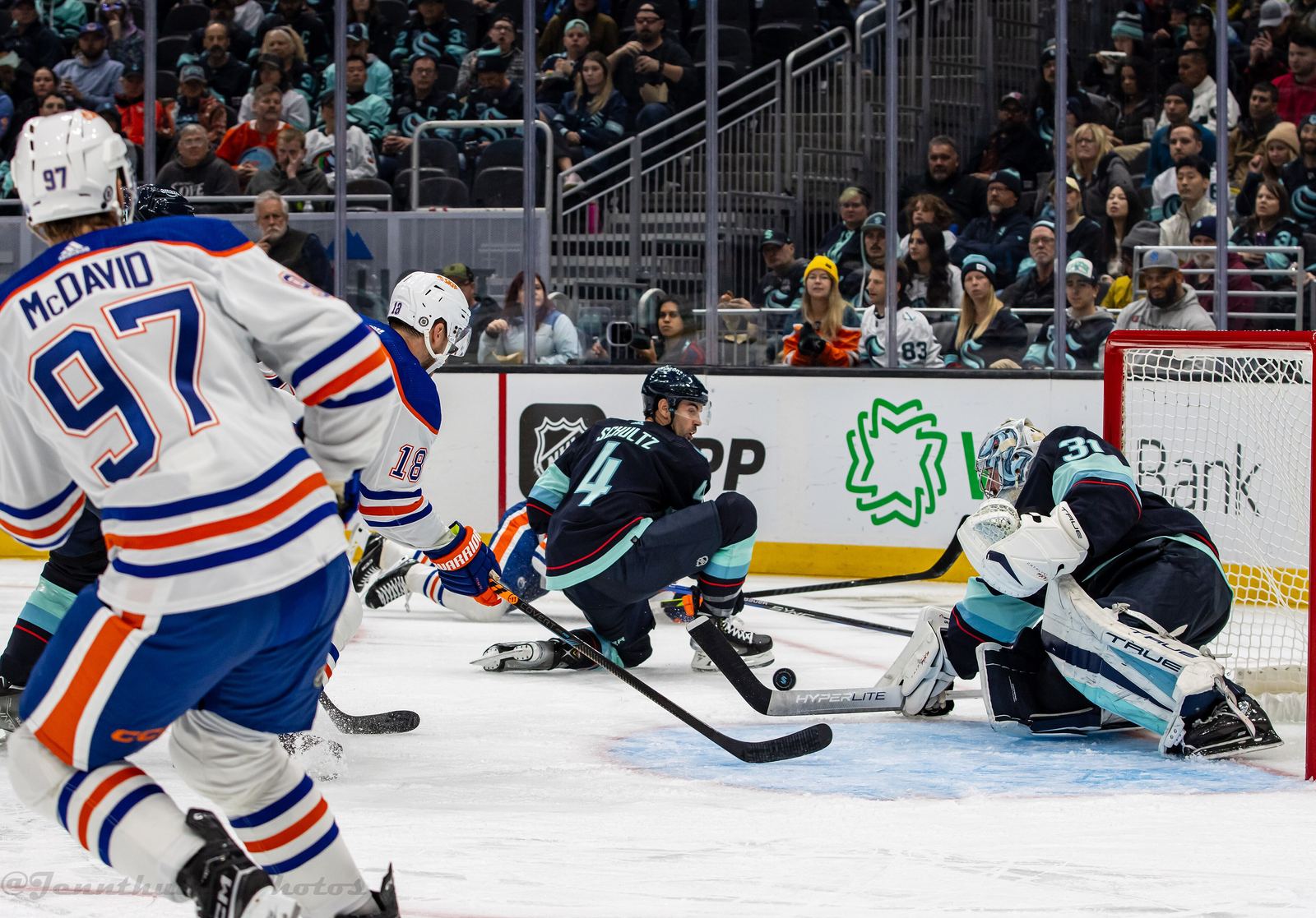 Connor McDavid, number 97 in an Edmonton Oilers away jersey, driving the net against the Seattle Kraken, October 2023.